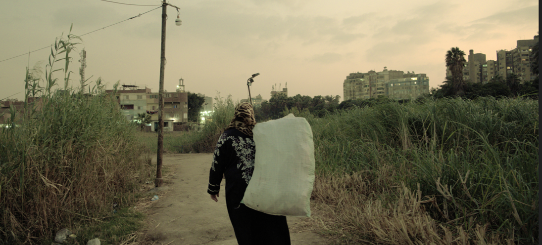 Woman Walking with a plastic bag in a field